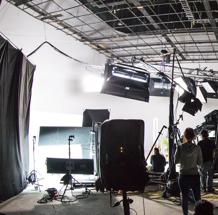 A production soundstage rigged with lighting and cameras.